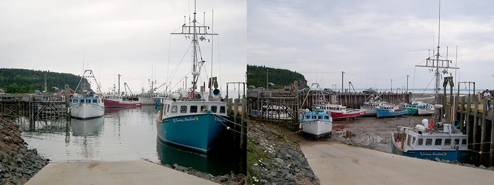 Two photos of the same marina at the Bay of Fundy and appear to be taken from the same location. The photo on the left was taken when the water is high, the water line is nearby and the boats are all floating in the water. The photo on the right was taken when the water is low. The water line is quite distant and the boats are resting on mud.