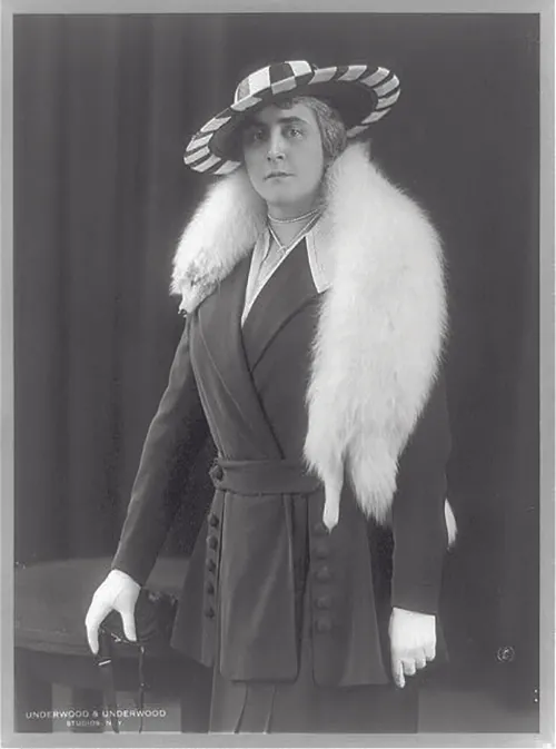 This image shows Anne Morgan wearing a fox stole over her shoulders, gloves, a hat, and a jacket and skirt.