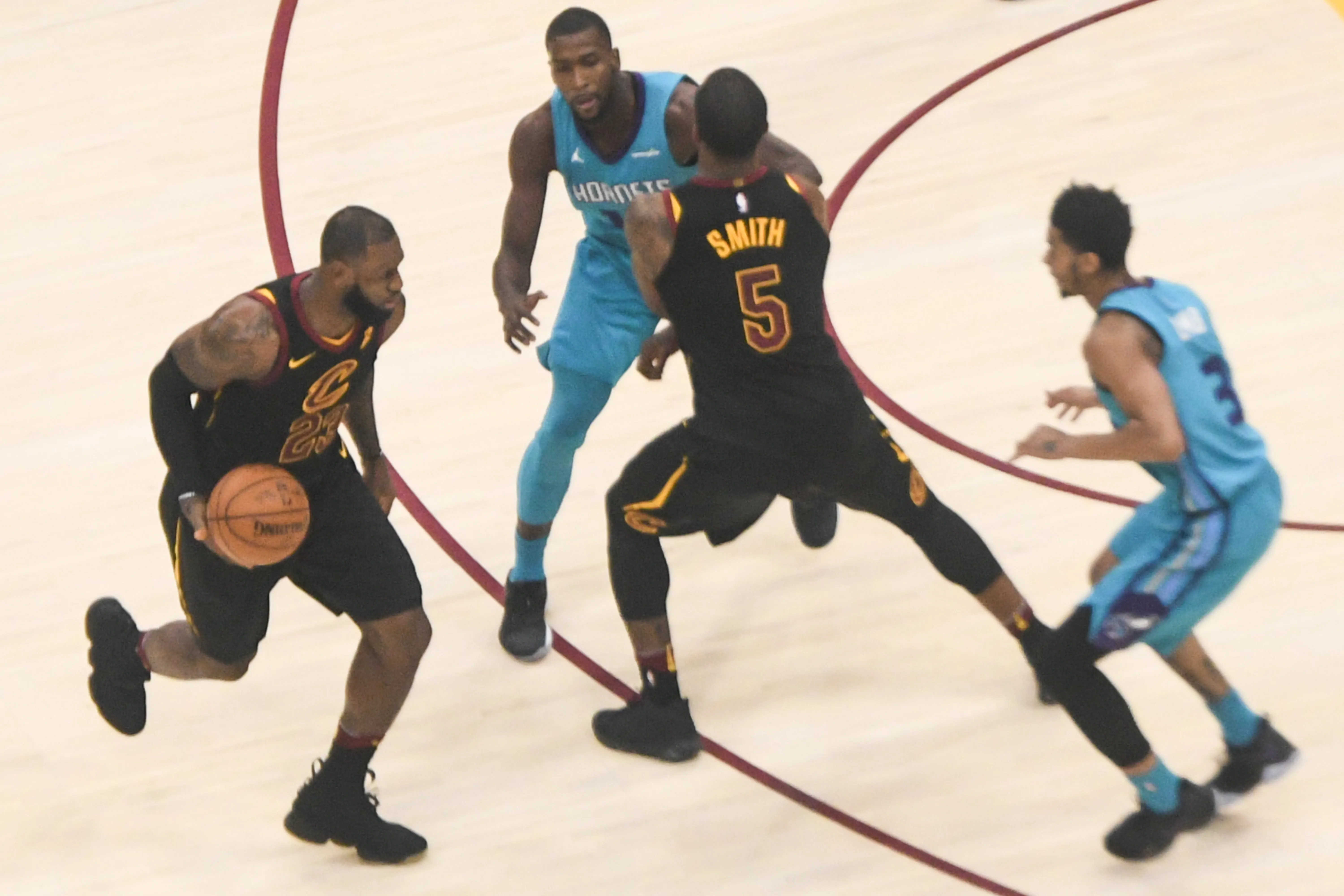 A photograph shows LeBron James dribbling a basketball during a basketball game