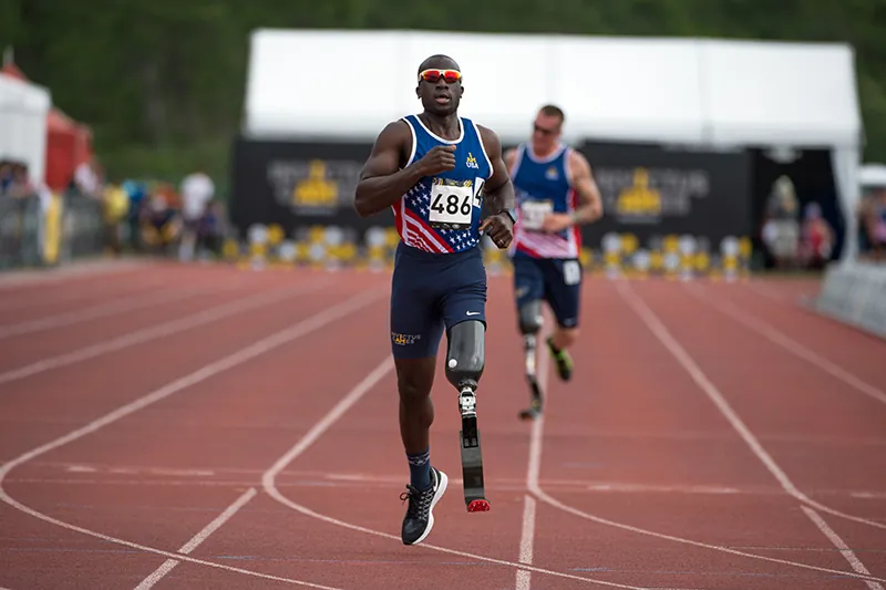 A photo shows U.S. Army veteran and captain of the U.S. Invictus team Will Reynolds races to a finish line with an artificial leg during the 2016 Invictus Games in Orlando.
