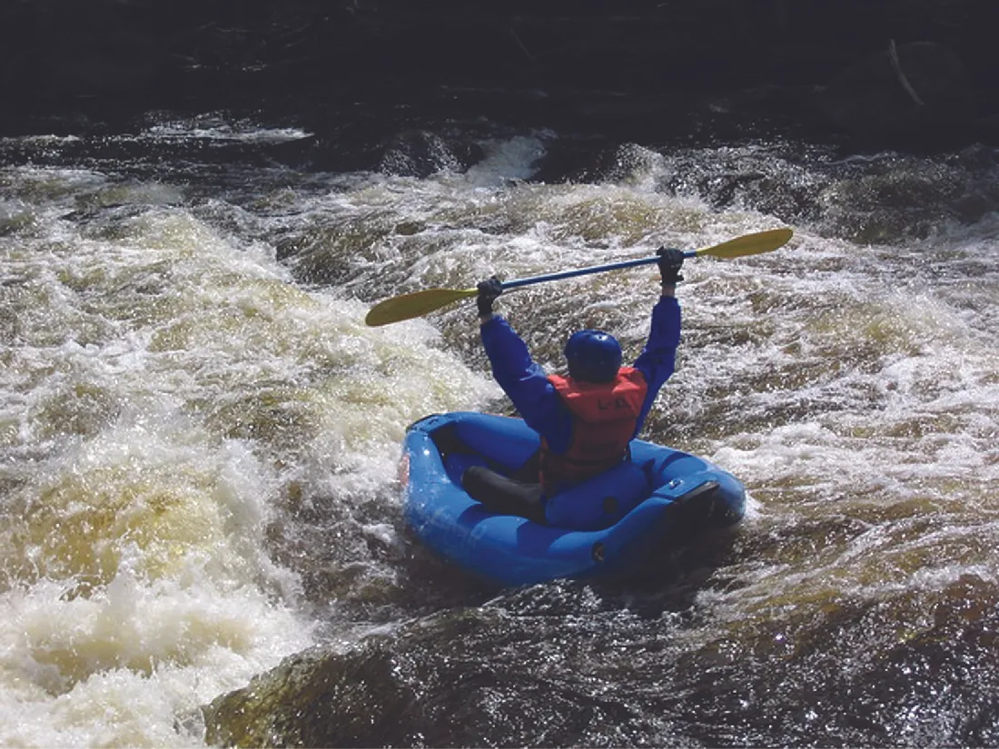 Photo of a person white-water rafting.