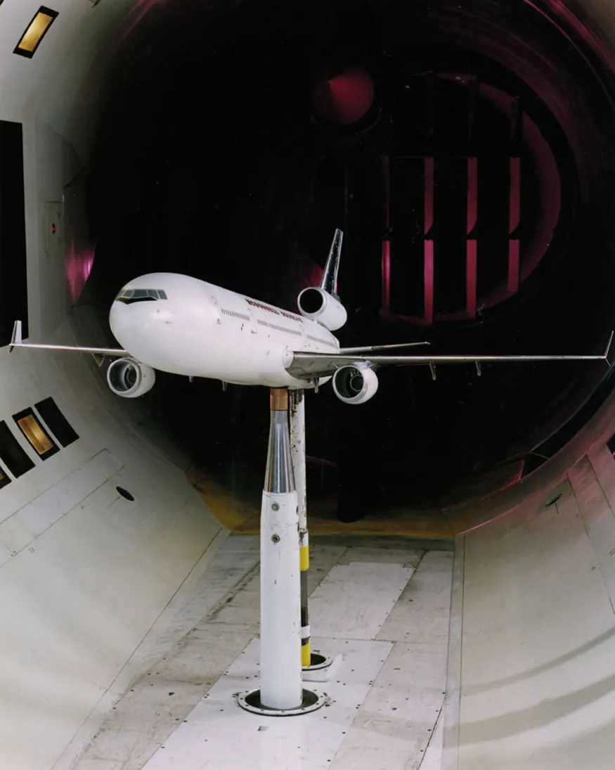 A model plane is can be seen being tested in a wind tunnel.