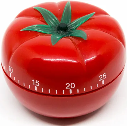 A Pomodoro kitchen timer, resembling a tomato with time increments marked along the center of its body.