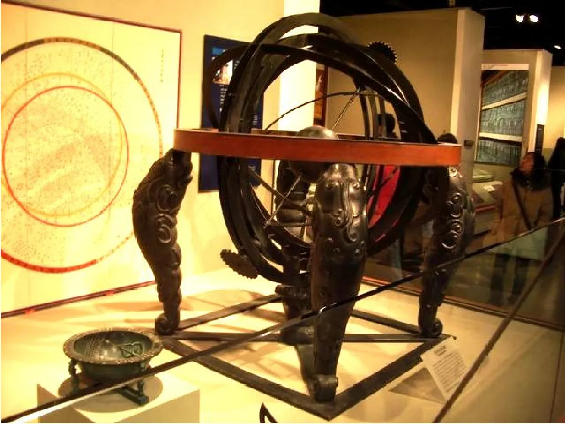 This photograph shows a black, celestial globe on display in a museum. Visitors to the museum and other exhibits are visible in the background.