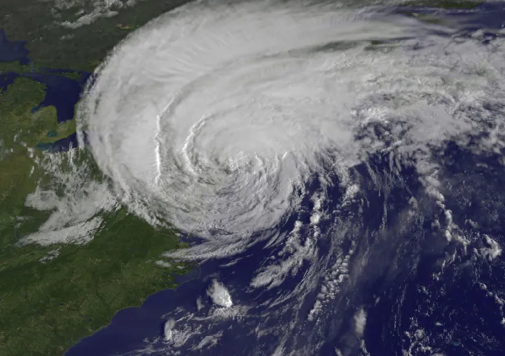 Image of a Hurricane from Space. This photograph shows a huge, inverted-comma shaped storm covering much of the north-east coast of the United States.