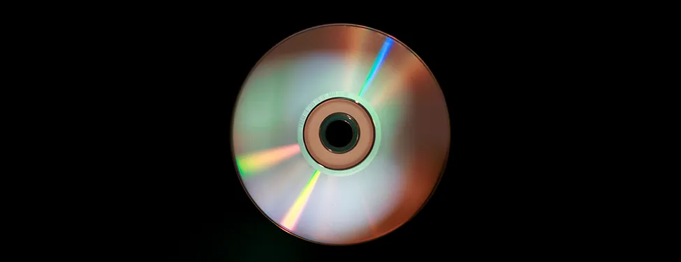 Photograph of a compact disc, showing arcs of rainbow colors produced by diffraction.