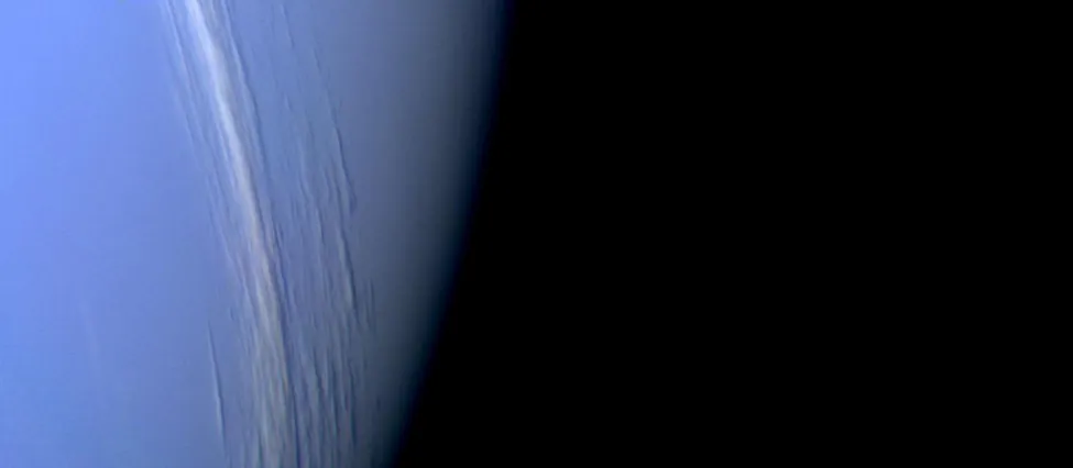 The White Clouds of Neptune. Thin clouds of methane ice crystals run nearly vertically from top to bottom center in this Voyager image of Neptune. These clouds have the appearance of cirrus clouds frequently seen on Earth.