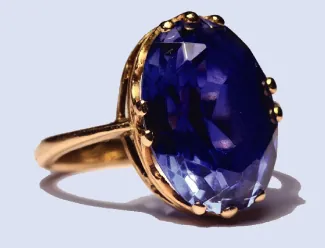 This is a photograph of a ring with a sapphire set in it.