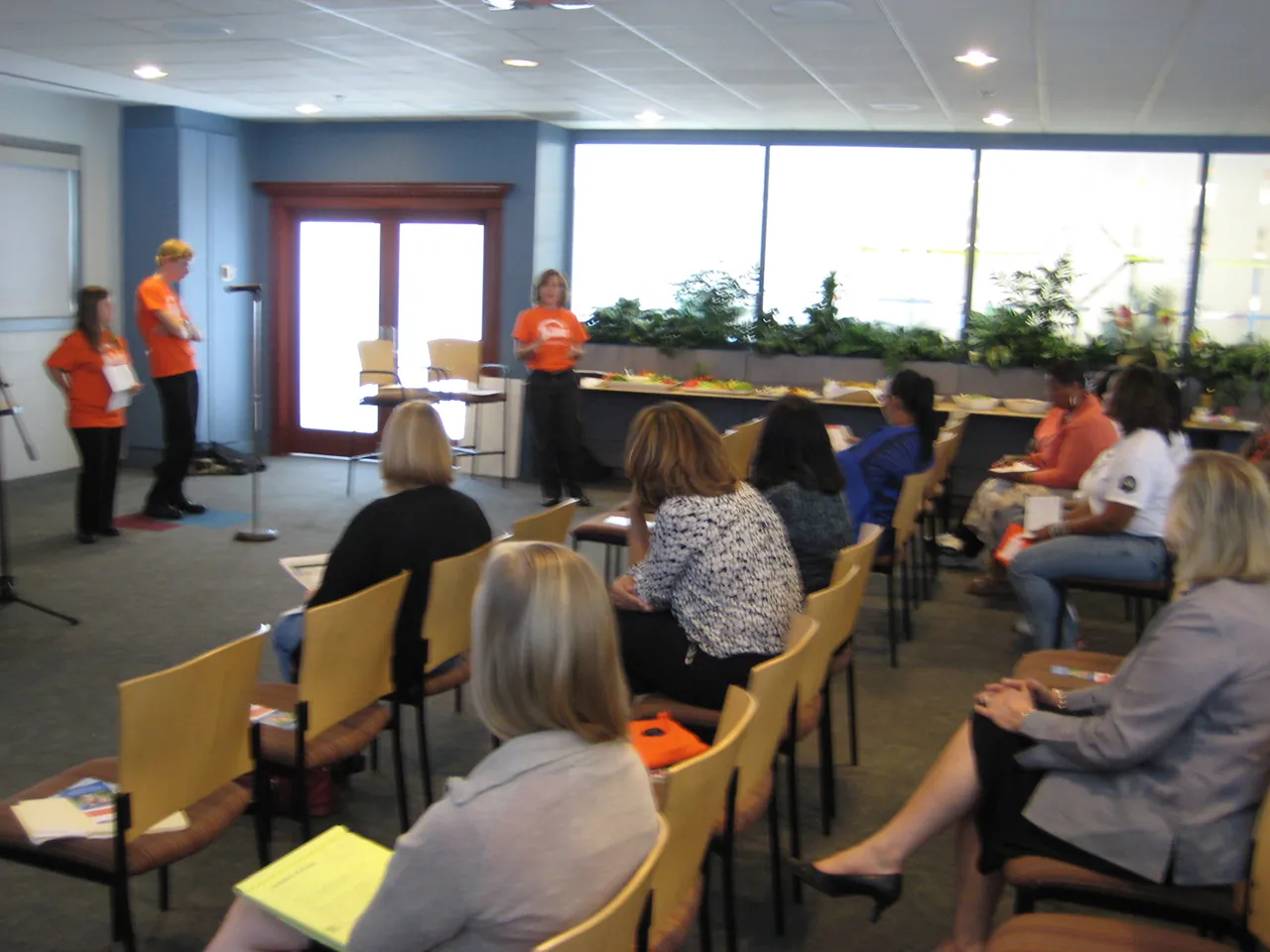 A photo shows the Northern Trust Bank staff watching a presentation presented by the Disability Awareness Players.
