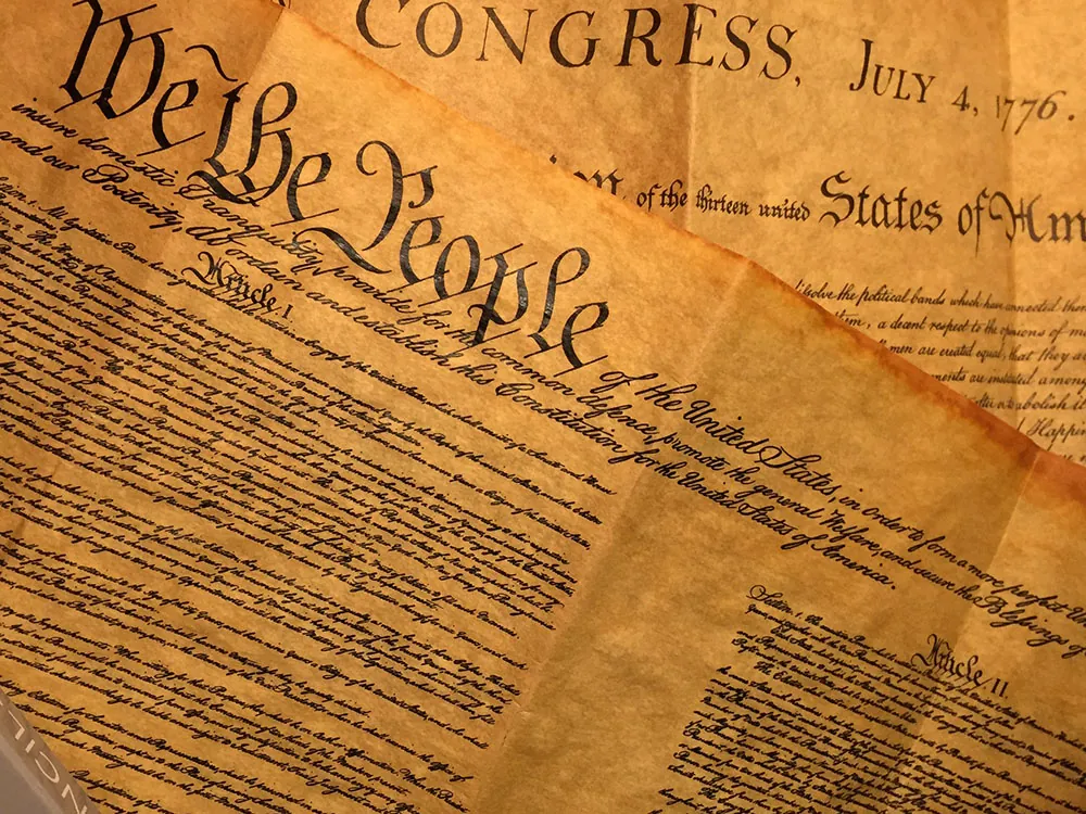 Old sheets of paper, on which the U.S. Constitution is printed.