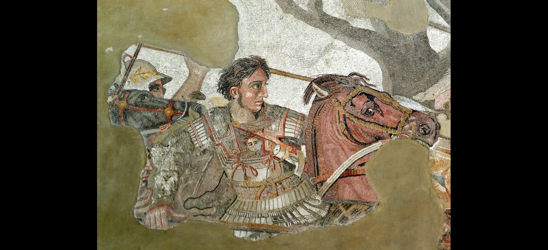 An image of a painting is shown, partially obscured at the left side and at the bottom with green colors. In the image, a man is shown riding on a brown horse with brown, black, and red reins. The man wears a silver suit of armor with red trim, has brown chin length hair, a large nose, and long sideburns. An image of a face shows in the armor on his chest. He holds a long brown spear. Behind the man a black horse head is seen and a man’s eye under a silver helmet with brown feathers. Black trees are seen in the background and a grayish sky.