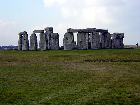 A photograph of Stonehenge shows large rocks sitting upright and other laying across the upright rocks. Stonehenge functions as an ancient astronomical observatory, with certain rocks in the monument aligning with the position of the Sun during the summer and winter solstices. Other rocks align with the rising and setting of the Moon during certain days of the year.