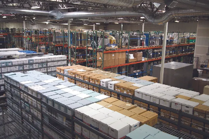 Photo of a factory floor, showing stacks of boxes.