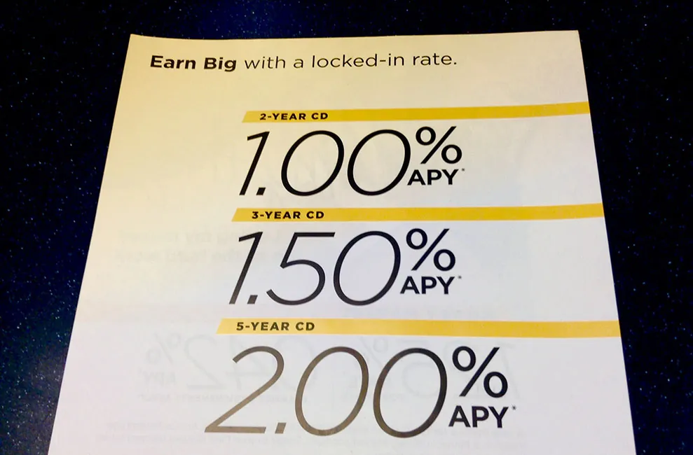 A sale paper titled 'Earn big with a locked-in rate'. The percentages for 2, 3, and 4 year C Ds are 1.00, 1.50, and 2.00