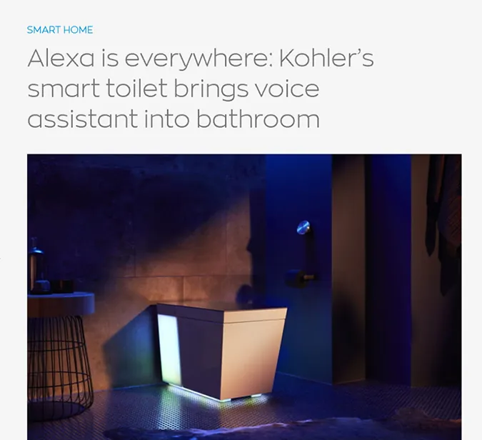 A rectangular toilet next to a sink with a caption that reads “Alexa is everywhere: Kohler’s smart toilet brings voice assistant to bathroom.”