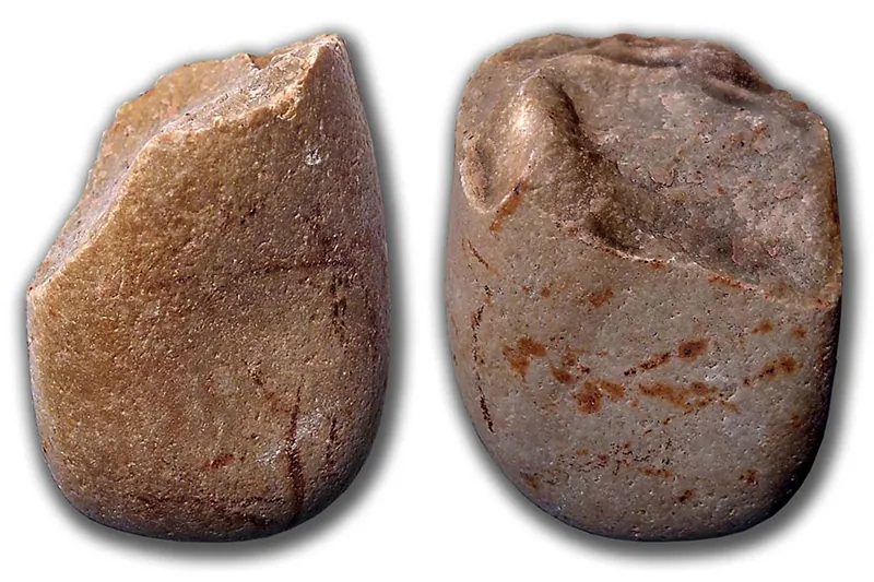 Two different views of a stone with the top chipped away and shaped to form an angled edge.