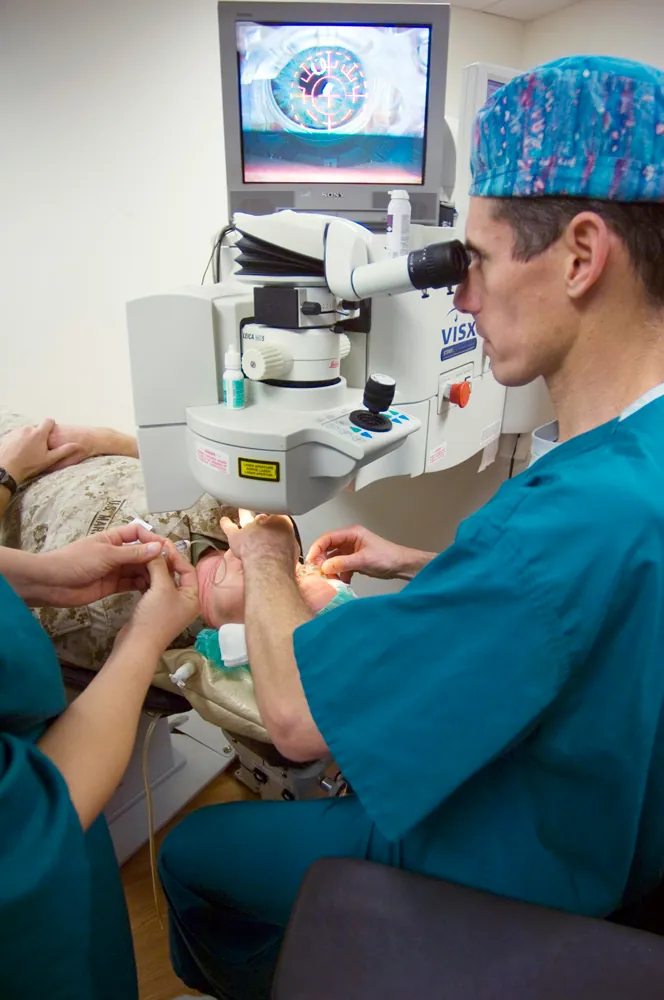 The image depicts a surgeon using state-of-the-art equipment for LASIK surgery on a patient who is lying down.