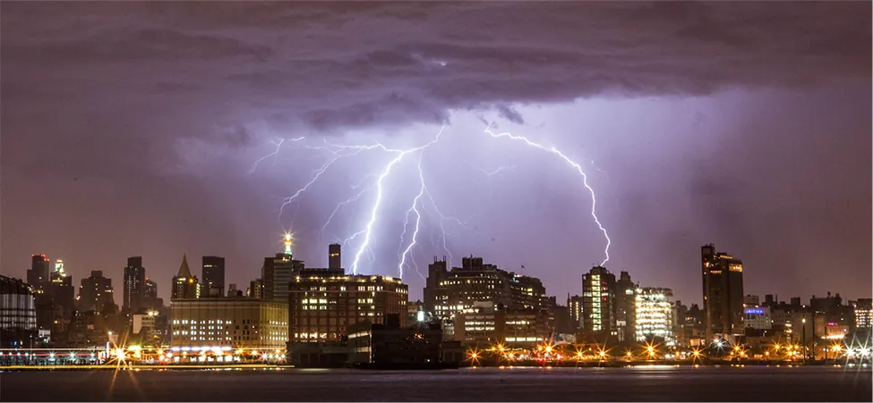 The photo shows lightning strike over several buildings.