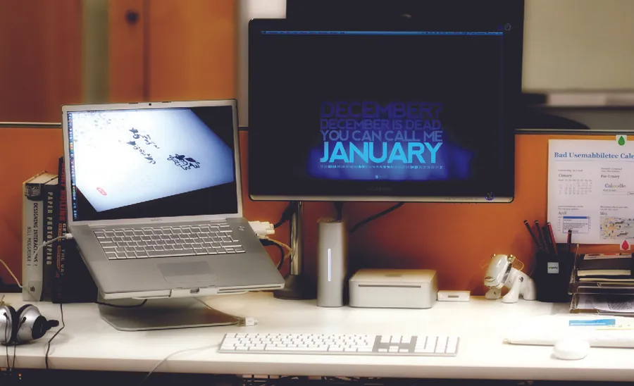 Photo of a laptop and separate monitor on a desk.