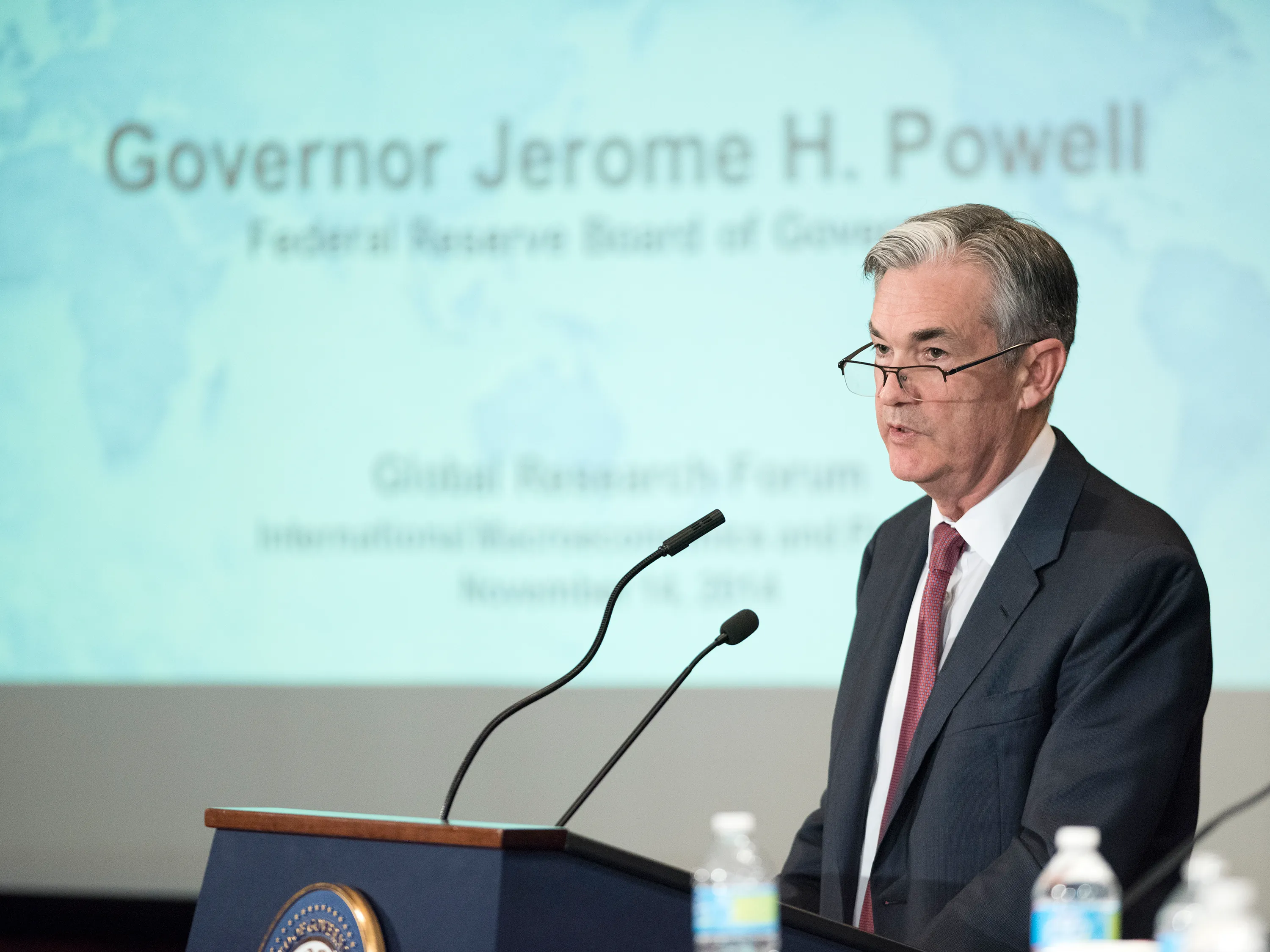 A photograph shows Fed Chairperson Jay Powell speaking at a podium.