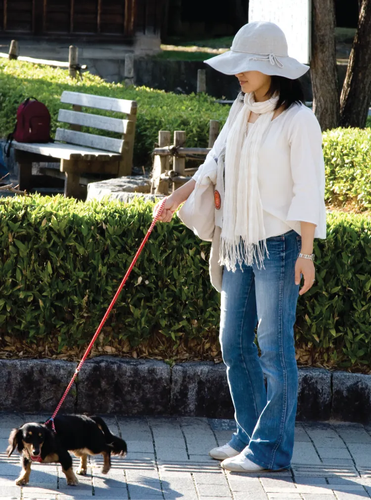 A woman walking a dog.
