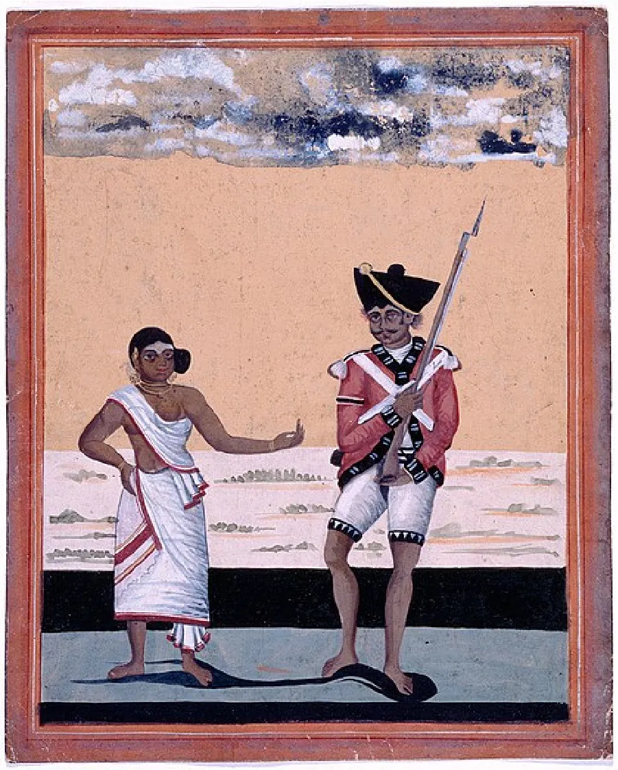 A painting shows a dark-skinned and barefoot man and woman standing on a blue floor with green grasses on a white field behind and blue clouds above. The woman on the left wears a white cloth with red trim wrapped around her body, with her arms and part of her stomach exposed, her black hair up in a side bun, and jewelry around her neck and on her head. Her left arm is extended out to the man. He wears a red military coat with black and white trim, white tassels on his shoulders, short white pants with black and white trim, and a black hat with gold trim. He has a black moustache and is carrying a musket rifle.
