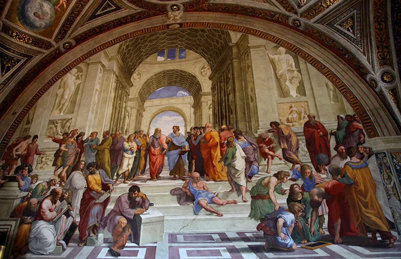The painting School of Athens shows a gathering of ancient people. They are gathered together in different groups, surrounded by stone arches and statues.