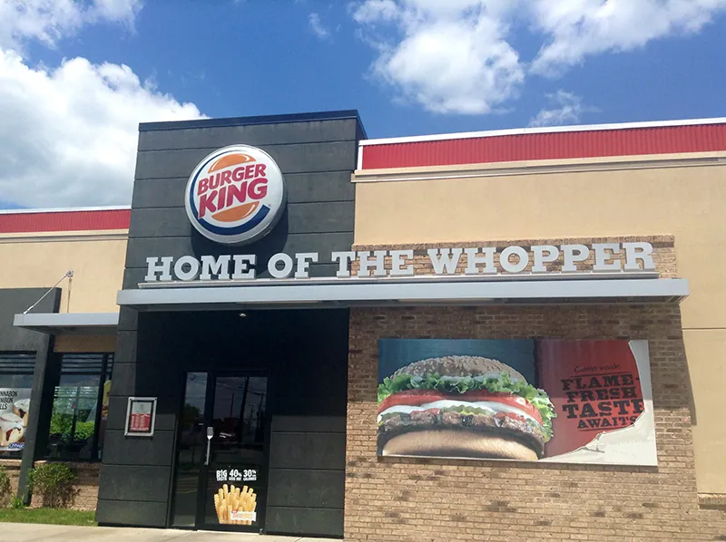 An entrance to a Burger King restaurant. The Words Home of the Whopper are below the Burger King logo and above the doorway.