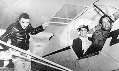 A photograph shows Eleanor Roosevelt smiling from her seat in a two-passenger plane, with an African American pilot in the front. Another African American airman stands beneath the wing.