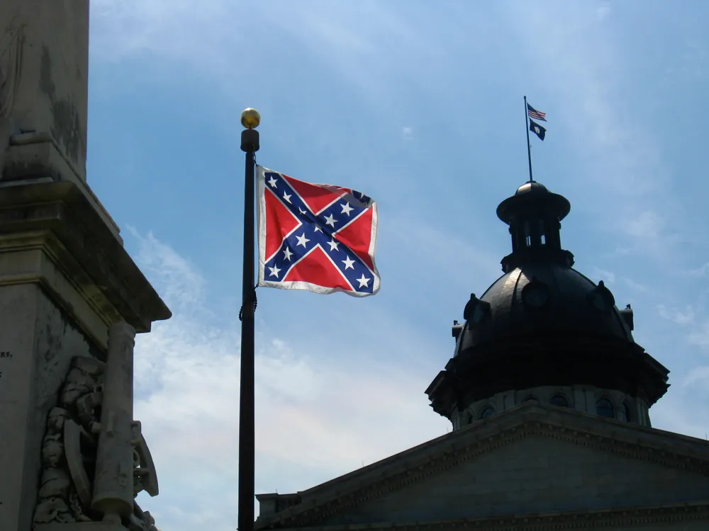 A photo of the Confederate flag hanging on a flagpole