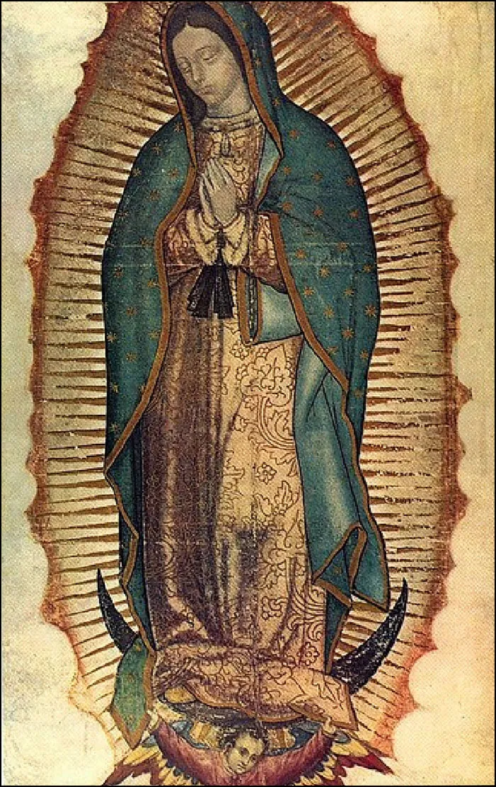 This is an image of the Virgin of Guadalupe. She wears a long dress and blue cloak, decorated with gold stars and trim. Her hands are clasped in prayer. A small child appears below her feet.