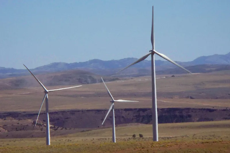 Landscape with three large wind turbines.