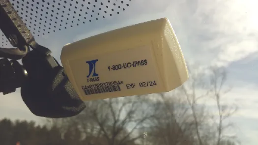A photo of an E-Z Pass attached to the inside of a car windshield.