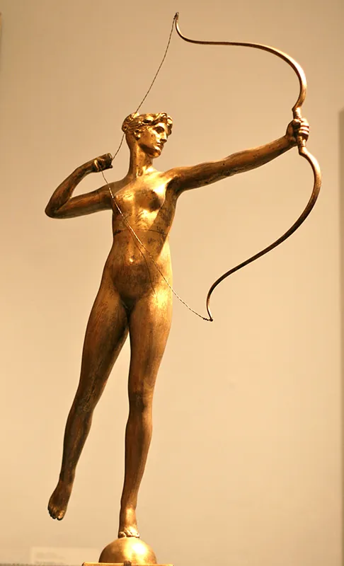 A golden statue of Diana, Roman goddess of hunt, She is holding a bow and has the bow string pulled back.