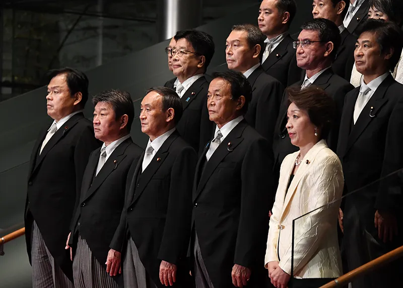 Members of the Japanese cabinet stand for a formal portrait with Prime Minister Yoshihide Suga.