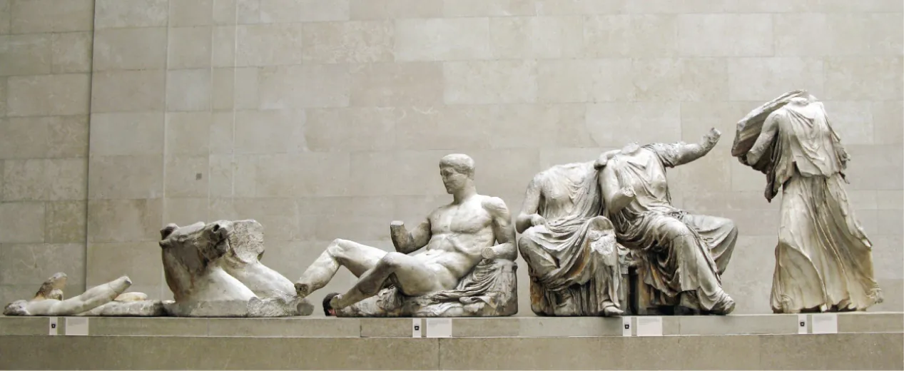 A series of ancient Greek statues on display in the British Musuem. Various parts are broken; two figures do not have heads, and several are missng hands.