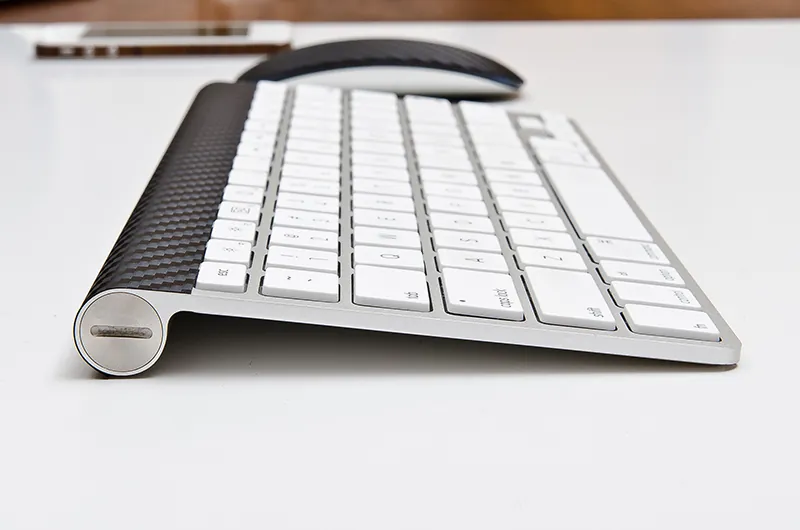 A keyboard and a mouse appear on a table.