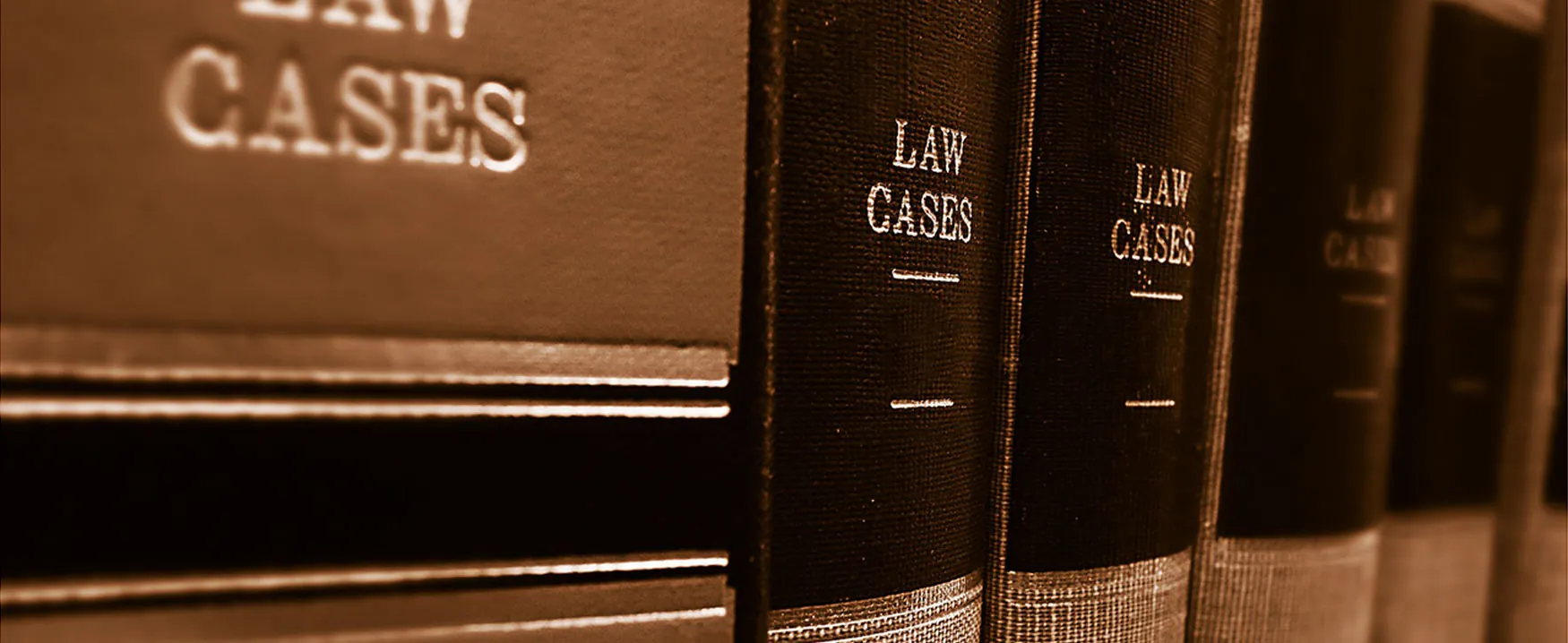 A close-up image of several thick, hard-bound books labeled “Law Cases.”