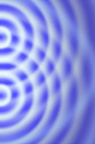 Se muestra una fotografía de un patrón de interferencia. Las ondas visibles como círculos blancos en la superficie azul emanan de dos centros y se cruzan en numerosos puntos.