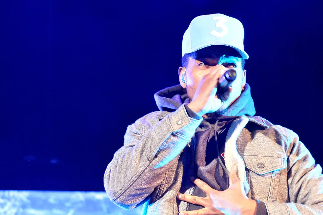 A photograph shows Chance the Rapper on stage with a microphone.