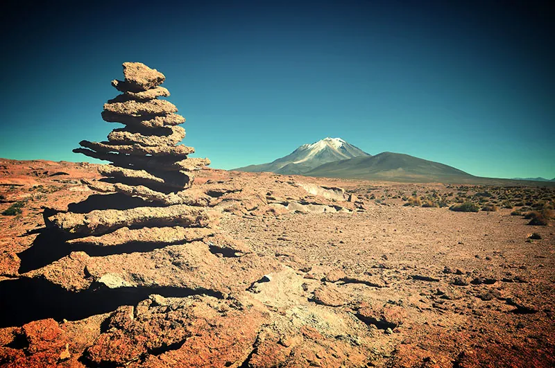 A stack of flat rocks in a barren landscape.