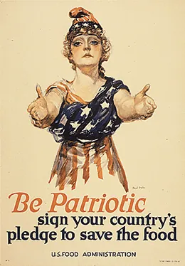 A poster shows a drawing of a young White woman with her arms outstretched toward the viewer. She wears an American flag wrapped around her body and a matching cap. The text reads “Be patriotic. Sign your country’s pledge to save the food. U.S. Food Administration.”