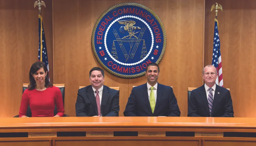 A photograph shows the commissioners of the FCC: Jessica Rosenworcel, Michael O'Rilley, Ajit Pai, and Brendan Carr.