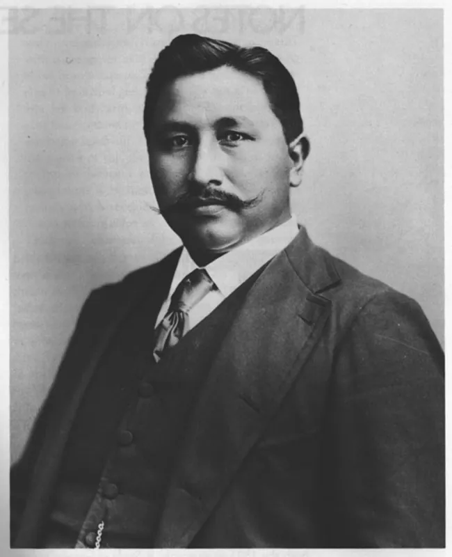 A black and white portrait of Francis La Flesche. He is dressed formally wearing a suit and tie.