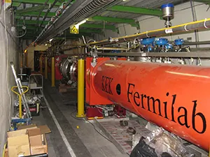 A photograph shows a large collider, called the Fermilab, with a long tube that allows subatomic particles to be accelerated.