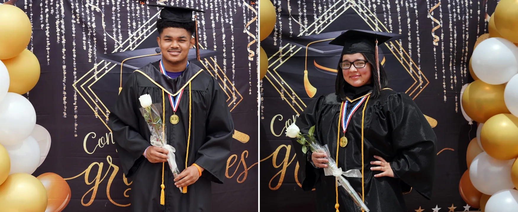 Two college graduates in caps and gowns smile with satisfaction as each holds a single white rose.