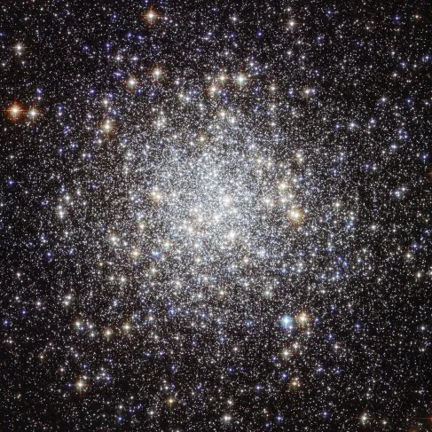 Image of a Star Cluster. This Hubble Space Telescope image of M9 shows a dense circular-shaped grouping of stars. The number of stars drops off dramatically toward the edges of the image, away from the center of the cluster.