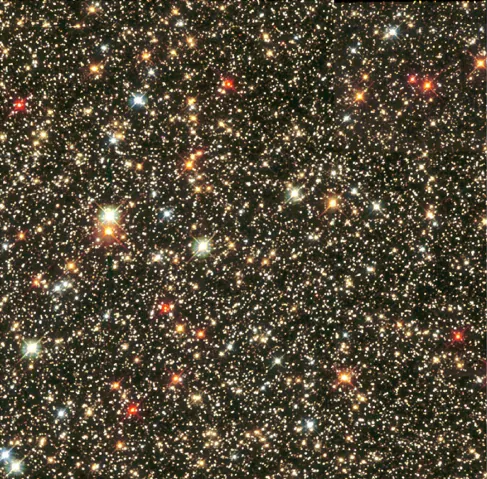 Hubble Space Telescope image of the Sagittarius Star Cloud. The image shows many stars of various colors, white, blue, red and yellow spread over a black background. The most common star colors in this image are red and yellow.
