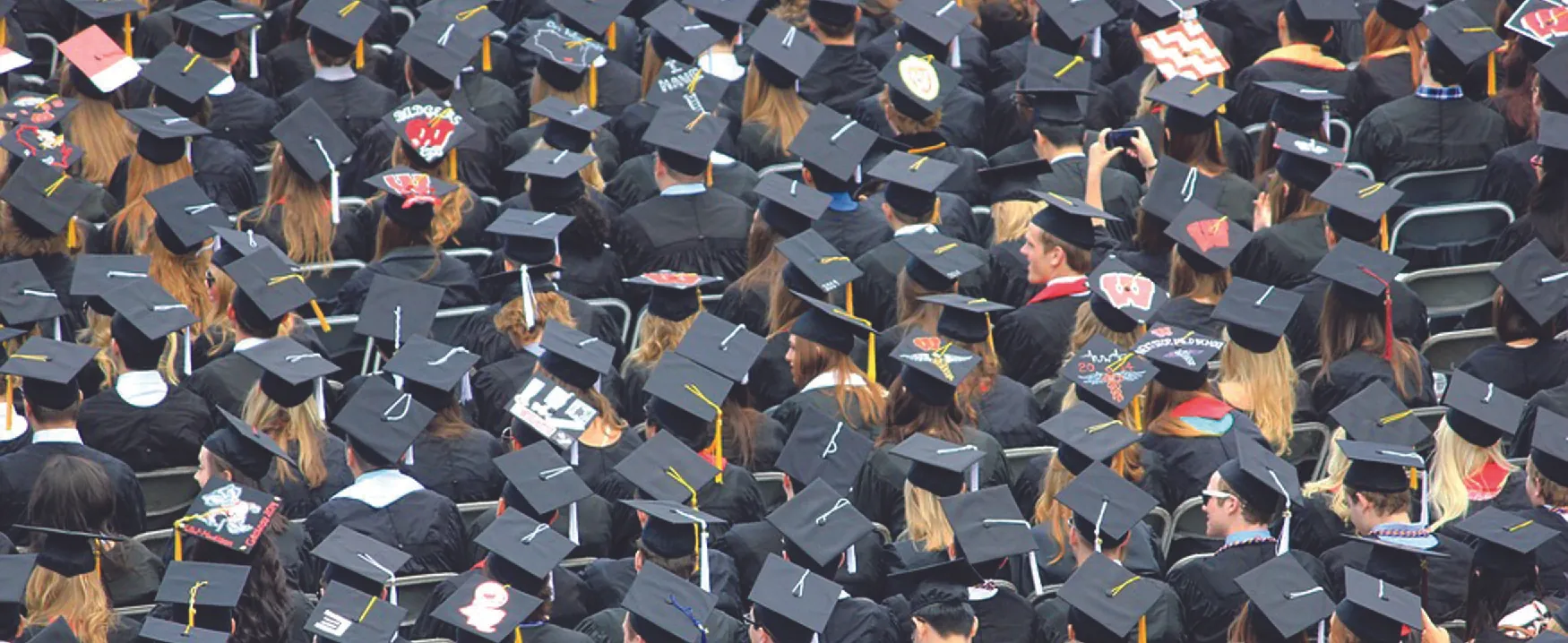 Photo of graduates in caps and gowns.