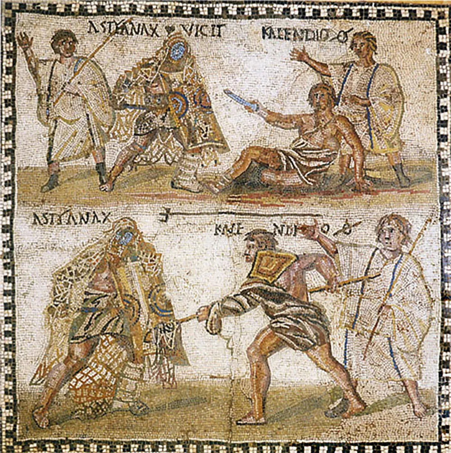 An image of a square mosaic is shown. The perimeter is alternating black and white squares and the inside shows two rectangular scenes. The scene at the top shows four figures. Words are printed across the top and the background is pale brown and white with the ground a darker shade of brown. The figure on the left stands with a thin brown spear holding his right hand up. He wears a white robe with colorful trim and has brown hair. The figure to the right is covered in a highly colorful cloak and one white, thick boot. His other foot is bare and his face is covered by a blue mask. He holds a sword in his right hand. The next figure to the right is on the ground wearing a waistcloth baring his shoulders. He has brown short hair and holds a short blue sword in his right hand. Pools of red surround him. Behind him stands a man in a white robe with black trim holding up his right arm. The scene below has a similar background with words across the top and a trident above the words. The cloaked figure from the top is shown at the left here in the same position and same clothing. The figure from the floor above is shown standing here aiming a spear at the cloaked figure. A gold shield shows behind his head. The man in a long white cloak from above is shown here standing in the right corner holding a long brown spear.